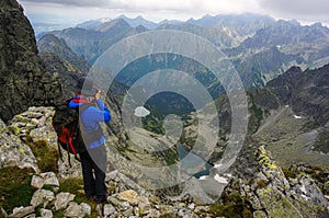 Photographer taking a picture in the mountains