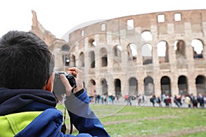 Photographer taking a picture of the Roman Colosseum amphitheate photo