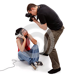 Photographer taking picture of sitting model