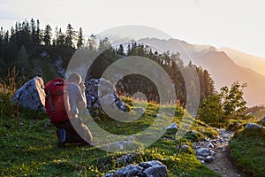 Photographer taking a picture of the sunset in the mountains of Tirol, Austria, near Gosau