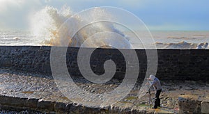 Photographer taking picture of wave