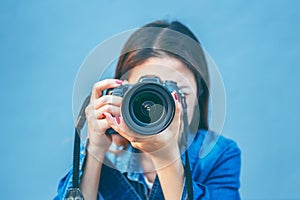 Photographer taking pictures with digital camera. Vintage tone