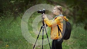 Photographer taking pictures, green forest