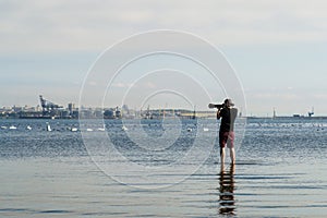 Photographer taking pictures of a group of swans.