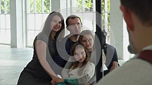 Photographer is taking pictures of a happy family with two sibling girls