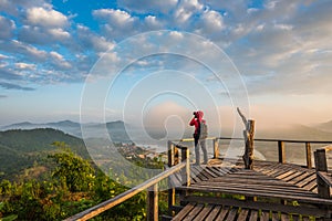 Photographer on the wooden bridge on sunrise at Phu Lam Duan view point