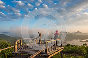 Photographer on the wooden bridge on sunrise at Phu Lam Duan view point