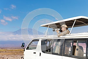 Photographer taking shots of Kilimanjaro mount