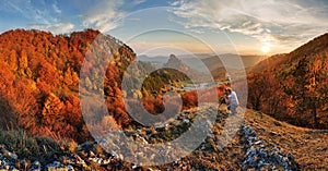 Photographer on top in mountain landscape