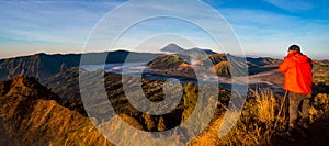 Photographer on the top of mountain to take a sunrise photo for Bromo vocano