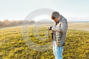 Photographer traveler adjusts the camera lifestyle professional activity hiker