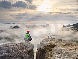 Photographer traveler thinking close to tripod with camera