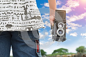 Photographer or traveller using a classic TLR Twin Lens Reflex