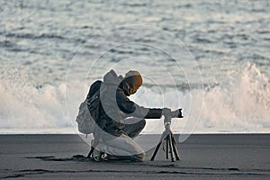 Photographer with tripod on an Icelandic beach