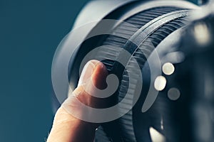 Photographer using zoom lens on DSLR camera