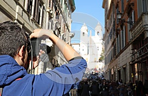photographer in Via dei Condotti in Rome Italy and the church of photo