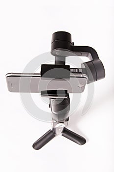 Photographer video gimbal with stabilizer on white background.