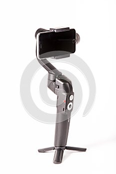 Photographer video gimbal with stabilizer on white background.