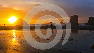 Photographer walking on the Pacific Coast