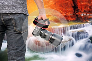 Photographer with Waterfall in deep forest