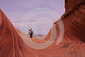 Photographer in Waves of Sandstone