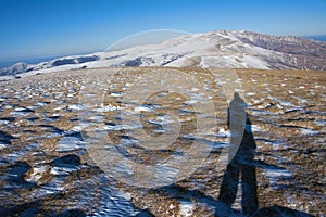 Photographer in winter mountain