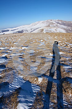 Photographer in winter mountain