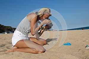 Photographer at work, jewelry photography on the beach