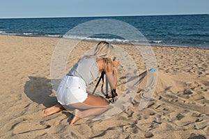 Photographer at work, jewelry photography on the beach