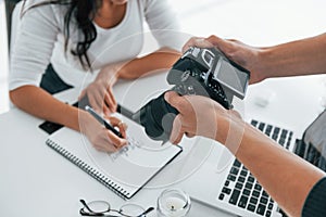 Photographer at work. Two young female freelancers indoors in the office at daytime