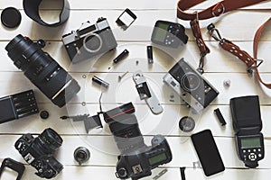 Photographer Workplace, Camera, Lenses And Accessories On White Wooden Background. Top View