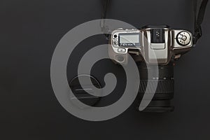 Photographer workplace with dslr camera system on dark black table background. Hobby travel photography concept
