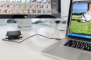 Photographers computer with photo edit apps/programs running