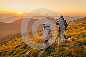 Photographers takes a sunset in the mountains photo