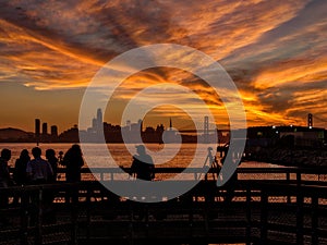 Photographers are taking a picture of sunset with San Francisco