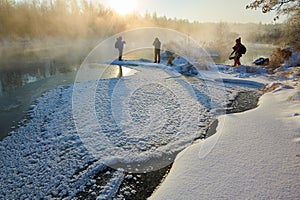 The photographers on the winter riverside