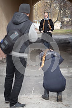 Photographers work with a model on the street