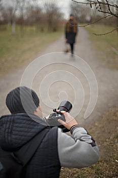 Photographers work with a model on the street