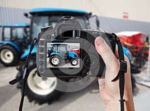 Photographic camera and blue agricultural tractor