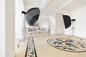 Photographic studio with modern lighting equipment. Light spring room studio interior. Luxury decor with daylight.