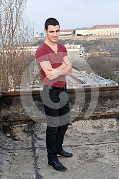 Photographing Danila MaziÃâ¡ on old roof with a background Petrovaradin fortress and Danube river