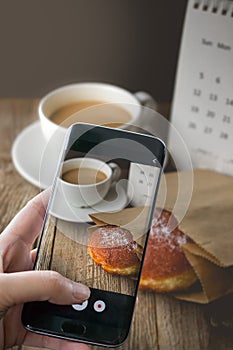 Photographing Hot Coffee and Donut on wood Background used for f