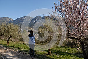 Person from behind, photographing beautiful spring  landscape photo