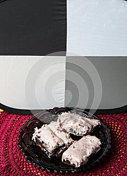 Photographing Mom`s homemade gooey chocolate brownies with pink cherry frosting