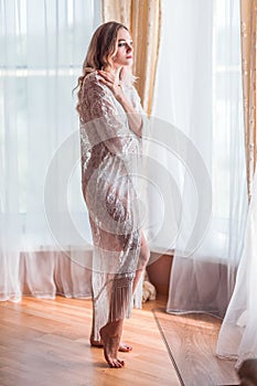 Photographing morning of the bride. Bride in a negligee