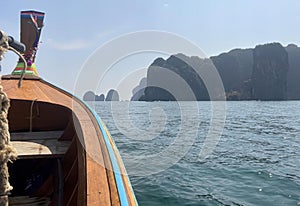 a photography of a boat with a rope on the front of it, sea - coast view of a boat with a long tail and a rope