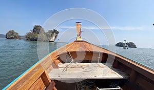 a photography of a boat with a table and chairs on the front, yawl boat with a table and chairs on the front of it