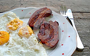 Photography of Breakfast in Serbia made of fried eggs and bacon photo