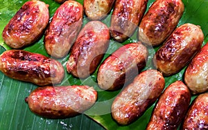 a photography of a bunch of sausages on a banana leaf, hot dog sausages on a banana leaf on a plate