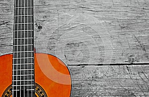 Photography of classical guitar neck over wooden background